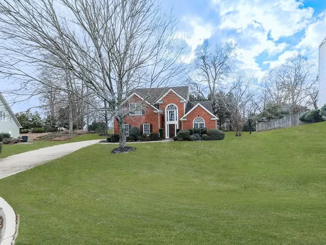 a front view of house with yard and green space