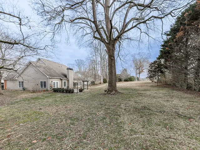 a view of white house with a snow in the yard
