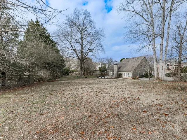 a backyard of a house with large trees