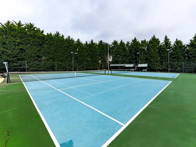 a view of an outdoor space and tennis court
