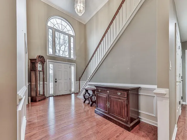 a view of entryway with wooden floor and stairs