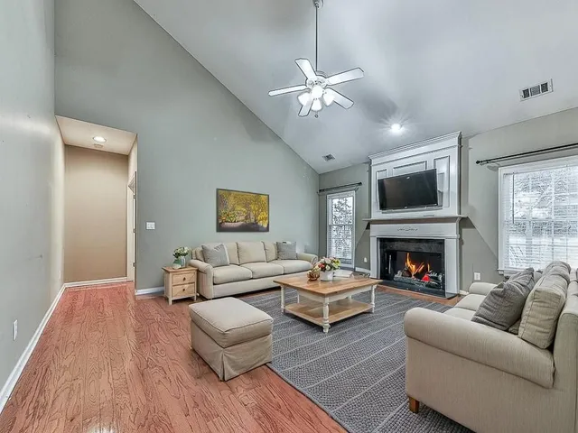 a living room with furniture fireplace and a window