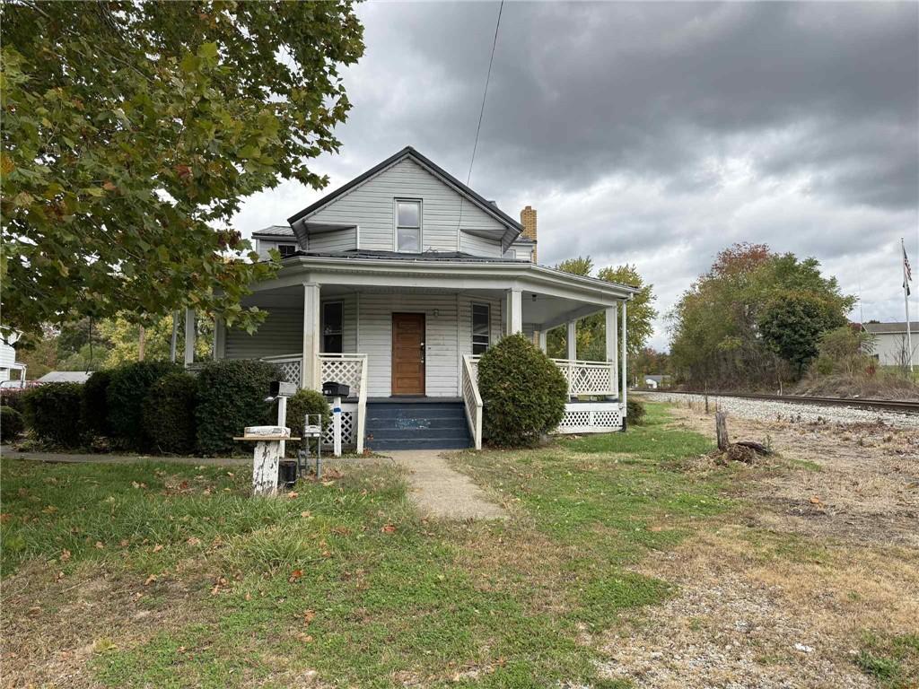 a view of a house with a yard and sitting area