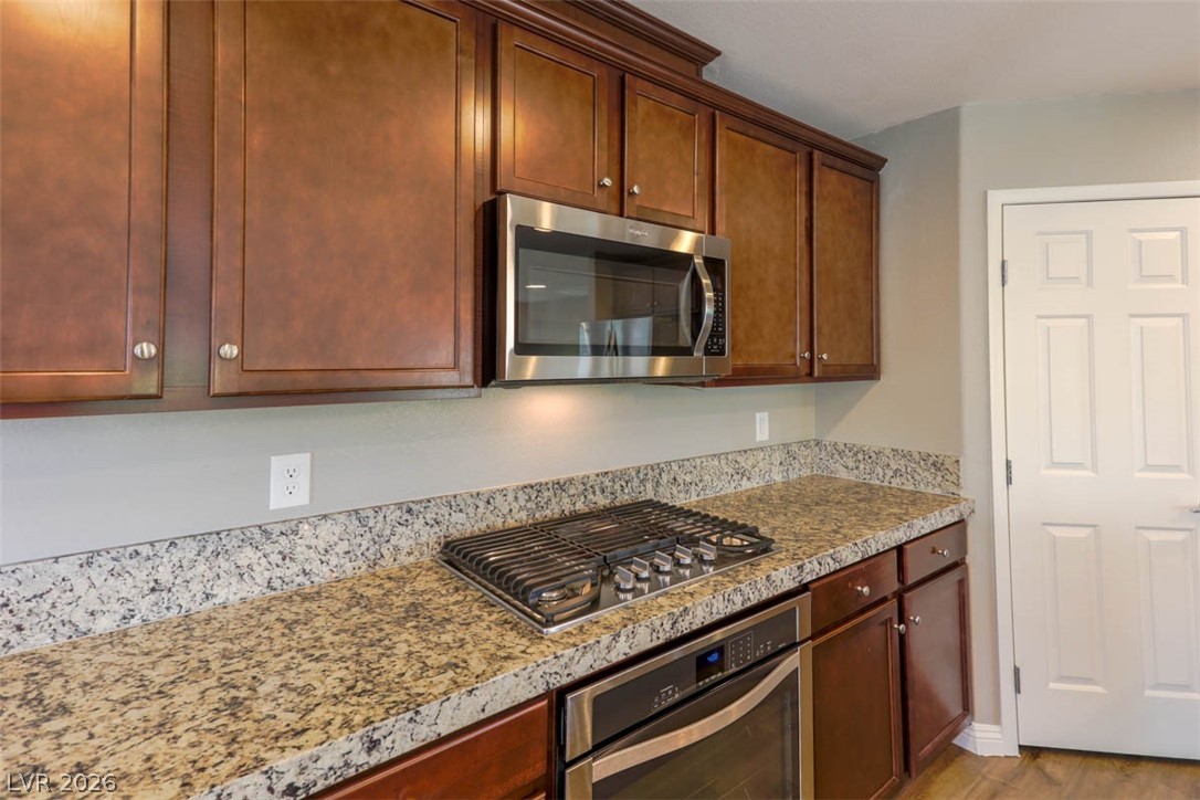 9940 Sable Point Street Las Vegas, NV 89178 - Photo 21 of 40 Kitchen with stainless steel appliances and light wood-type flooring