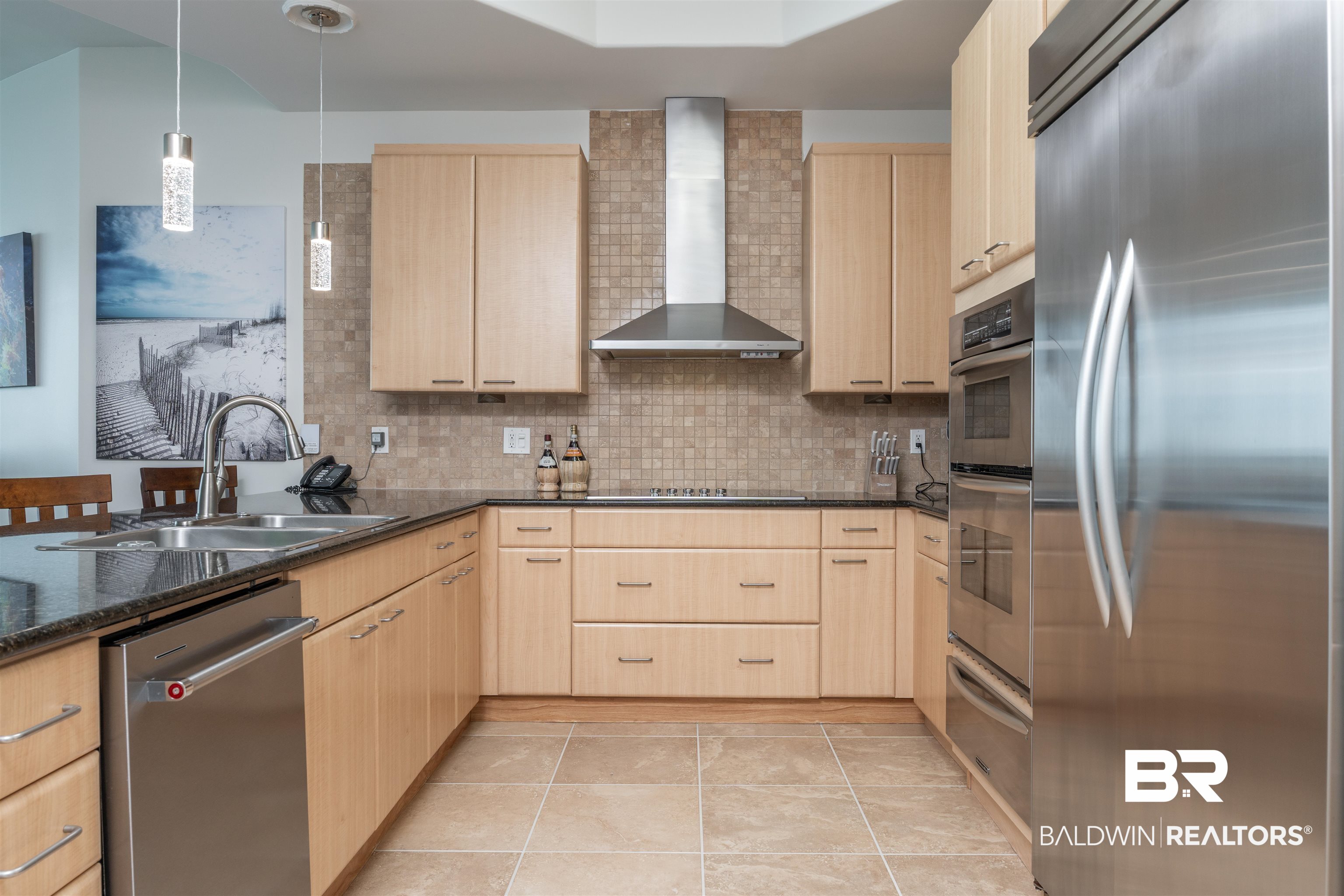 28107 Perdido Beach Boulevard, Unit DPH05 Orange Beach, AL 36561 - Photo 7 of 43 Kitchen featuring stainless steel appliances, decorative light fixtures, light wood finish cabinetry, backsplash, and a warming drawer