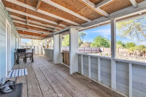 a view of a patio with table and chairs and wooden floor