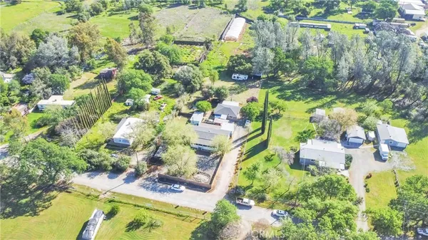 an aerial view of a house with a yard and lake view
