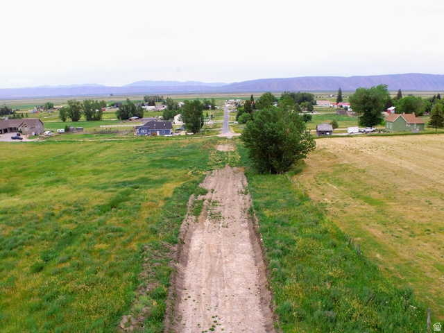 357 West 3rd Street North Bloomington, ID 83223 - Photo 9 of 10 Expansive open fields with a developing dirt road extending towards a distant community