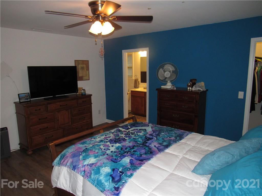 8188 Thornton Street Locust, NC 28097 - Photo 14 of 36 a bedroom with a bed and a flat tv screen on dresser
