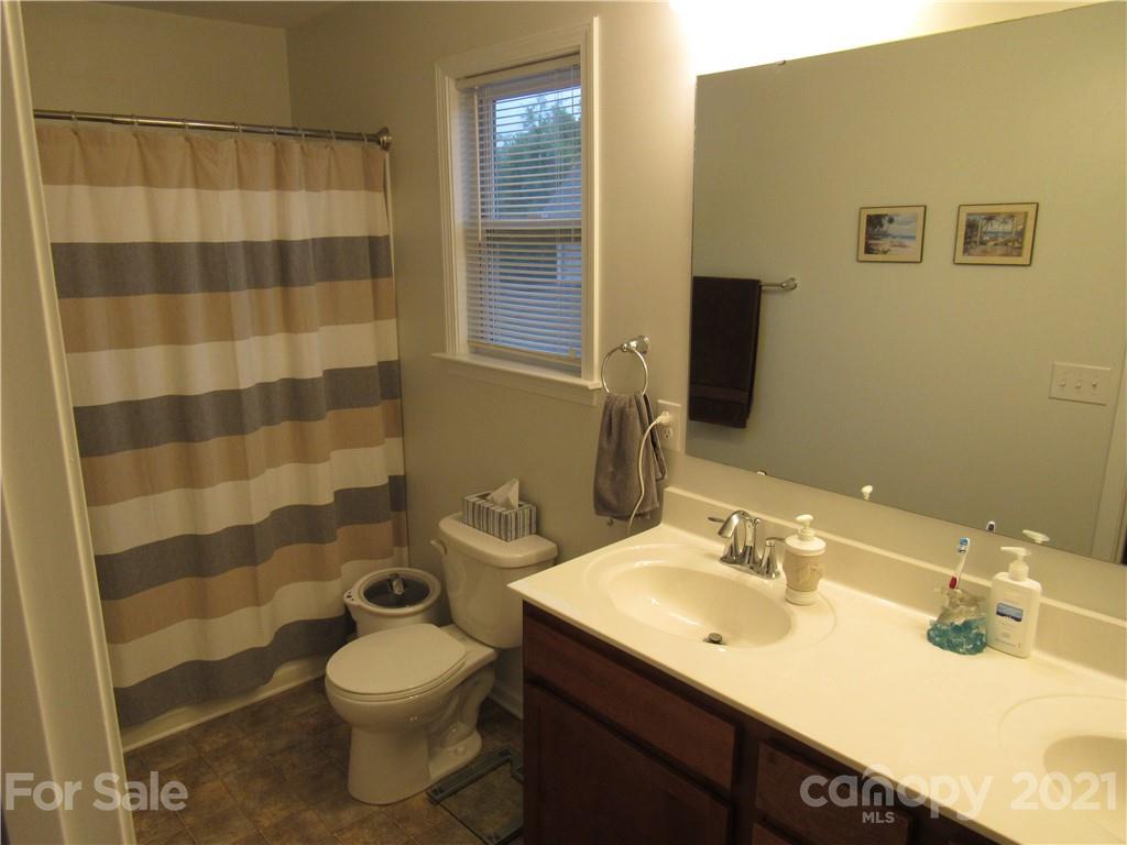 8188 Thornton Street Locust, NC 28097 - Photo 15 of 36 a bathroom with a sink toilet and shower