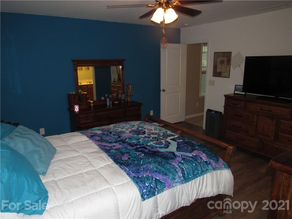 8188 Thornton Street Locust, NC 28097 - Photo 16 of 36 a bedroom with a bed and a flat screen tv