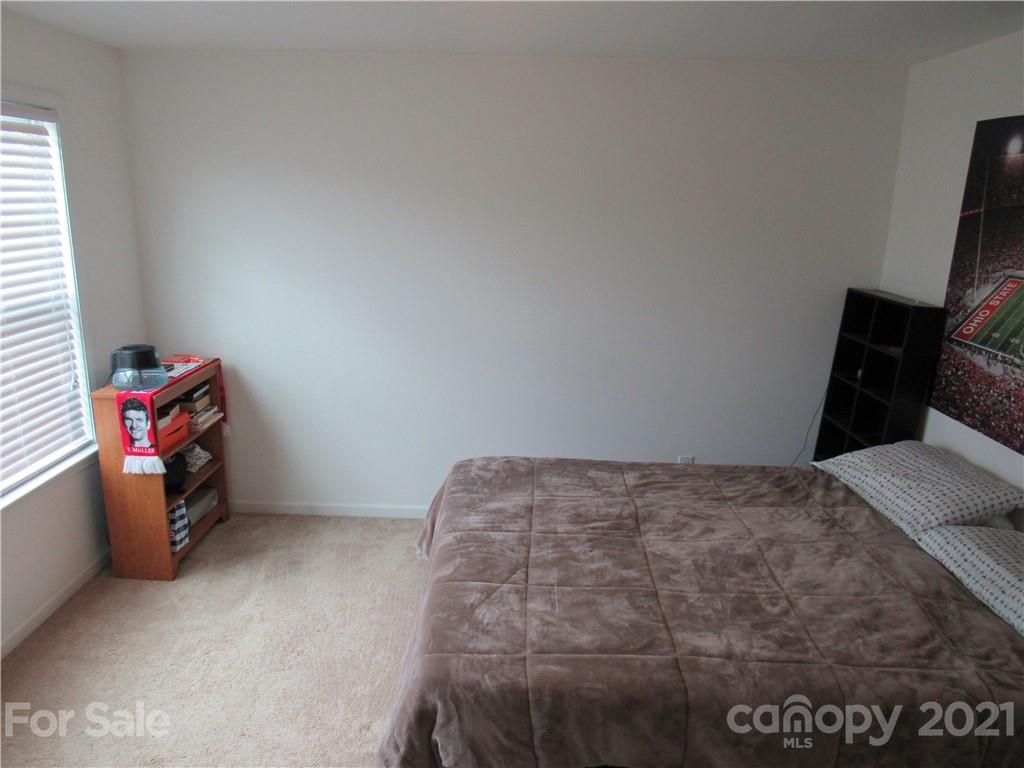 8188 Thornton Street Locust, NC 28097 - Photo 21 of 36 a bedroom with a bed and cabinets