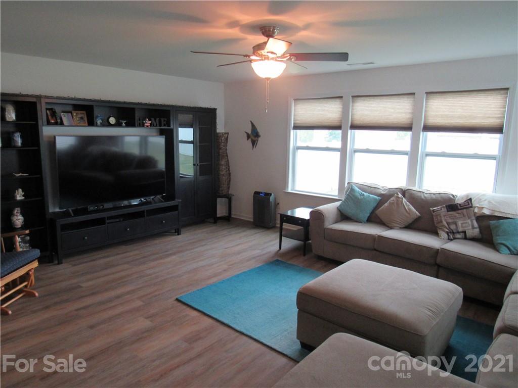 8188 Thornton Street Locust, NC 28097 - Photo 25 of 36 a living room with furniture and a flat screen tv
