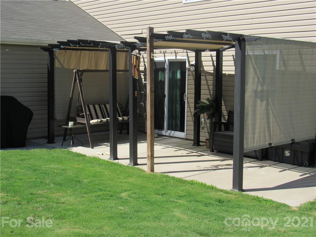 8188 Thornton Street Locust, NC 28097 - Photo 27 of 36 a view of a house with backyard and porch