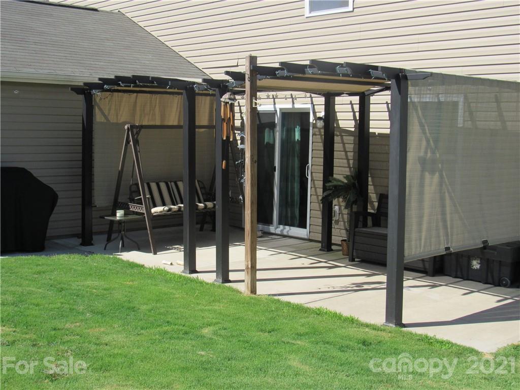 8188 Thornton Street Locust, NC 28097 - Photo 28 of 36 a view of a house with backyard and porch
