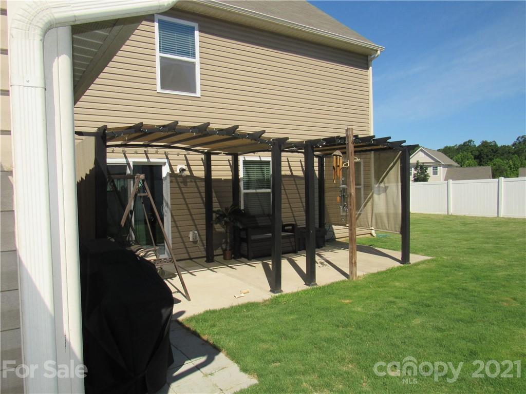 8188 Thornton Street Locust, NC 28097 - Photo 29 of 36 a view of a house with backyard and a garden