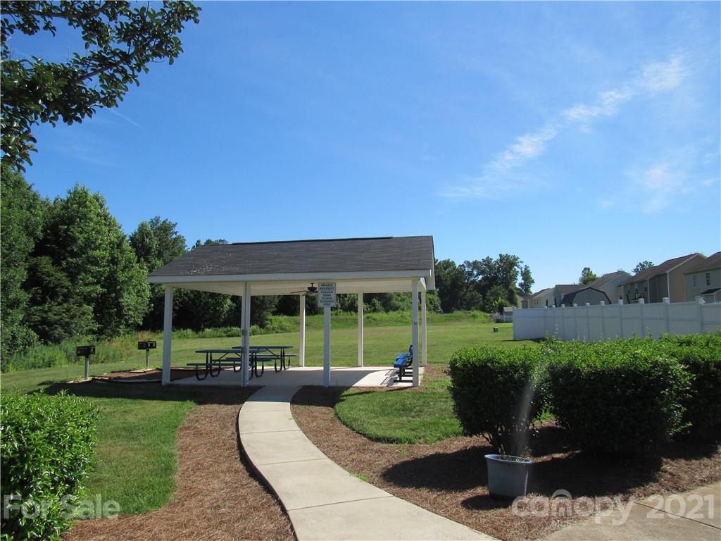 8188 Thornton Street Locust, NC 28097 - Photo 30 of 36 a view of a house with backyard sitting area and garden