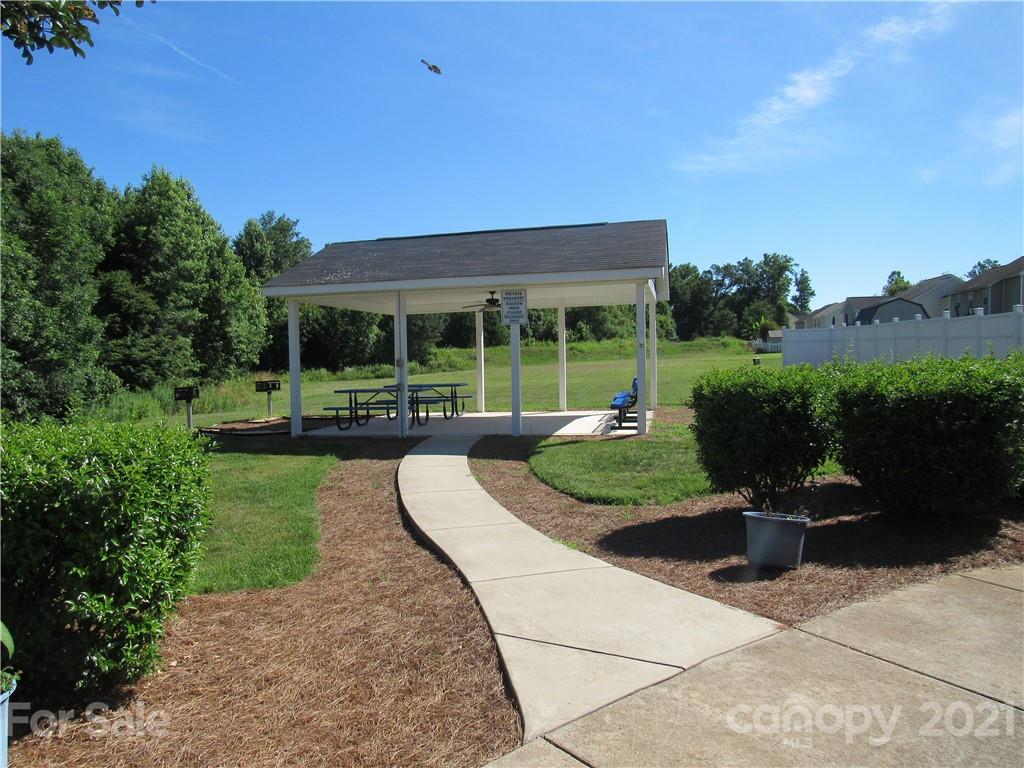 8188 Thornton Street Locust, NC 28097 - Photo 31 of 36 a view of a patio with table and chairs potted plants with floor to ceiling window