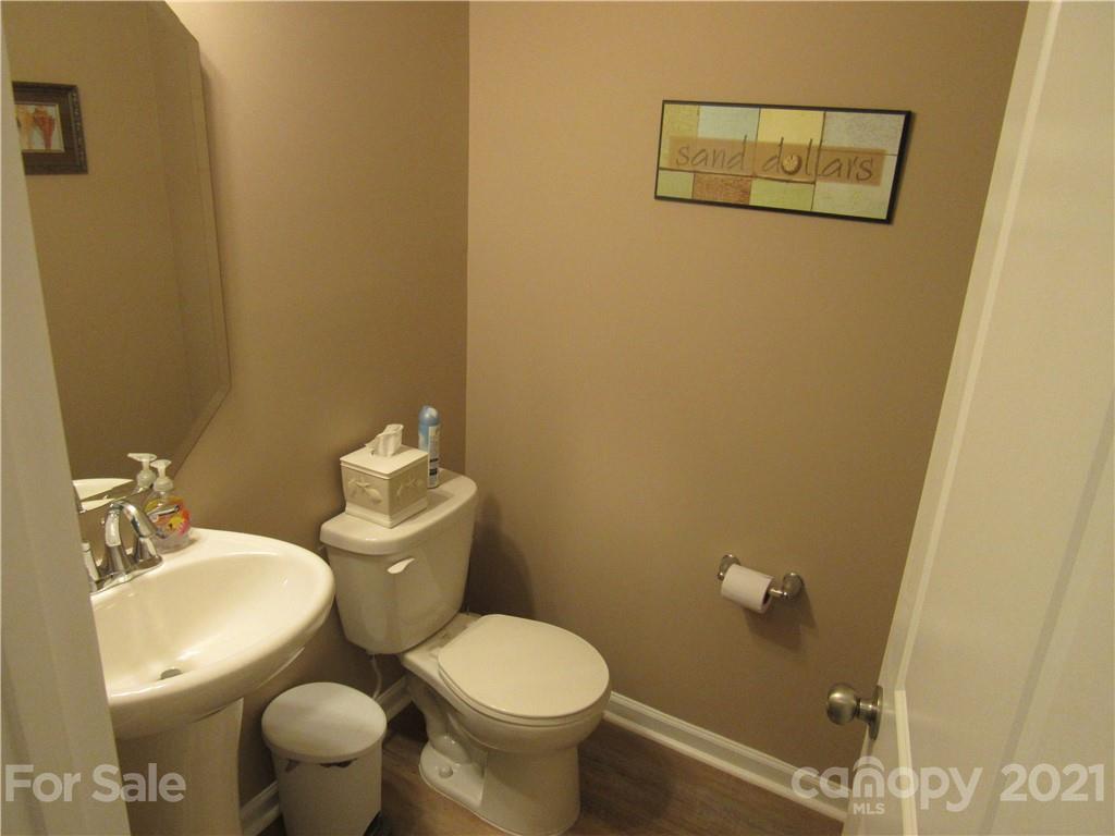 8188 Thornton Street Locust, NC 28097 - Photo 6 of 36 a white toilet sitting next to a bathroom sink