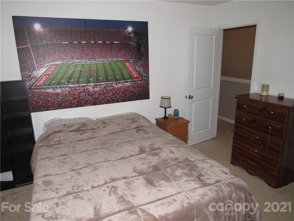 8188 Thornton Street Locust, NC 28097 - Photo 7 of 36 a bedroom with a bed and a television