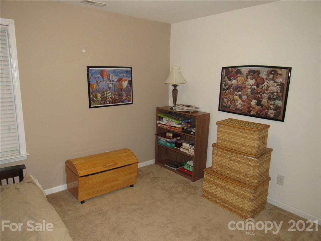 8188 Thornton Street Locust, NC 28097 - Photo 10 of 36 a bedroom with a bed and a desk