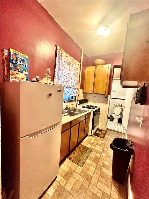 767 Eastern Parkway, Unit 1A Brooklyn, NY 11213 - Photo 11 of 12 a kitchen with a refrigerator and a stove