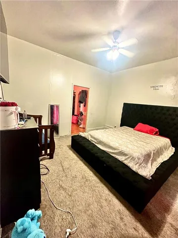 a bed room with a bed and a television