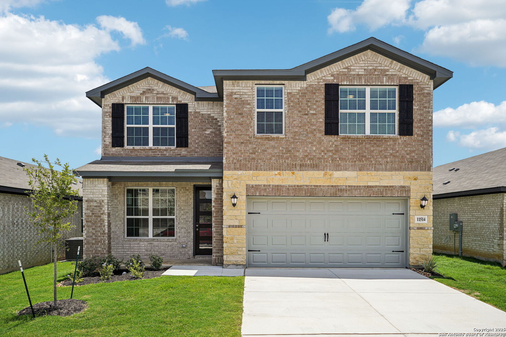 a front view of a house with a yard and garage