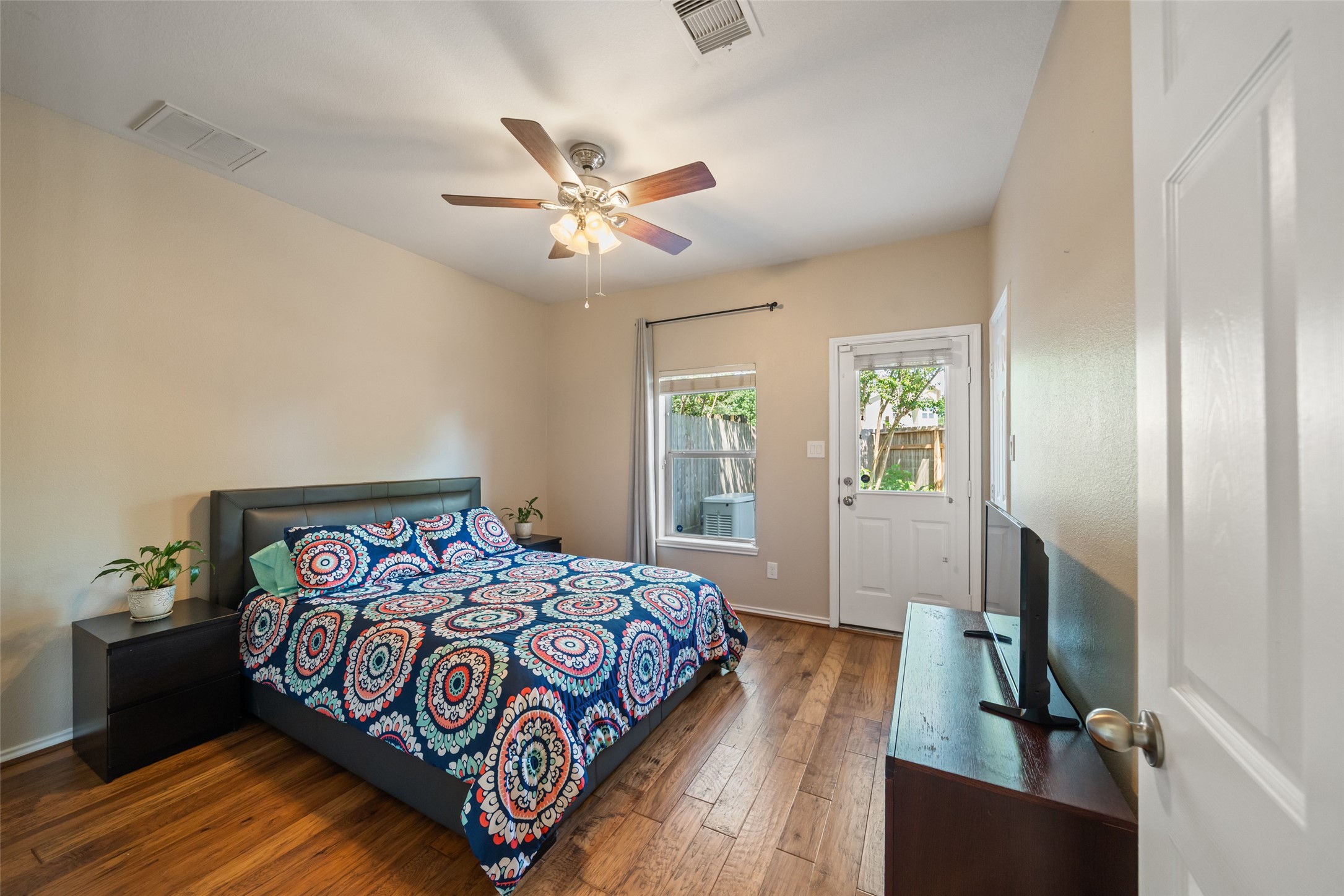 2613 Link Road Houston, TX 77009 - Photo 9 of 28 The guest bedroom is located downstairs and features lovely engineered hard wood floors and a spacious walk-in closet.
