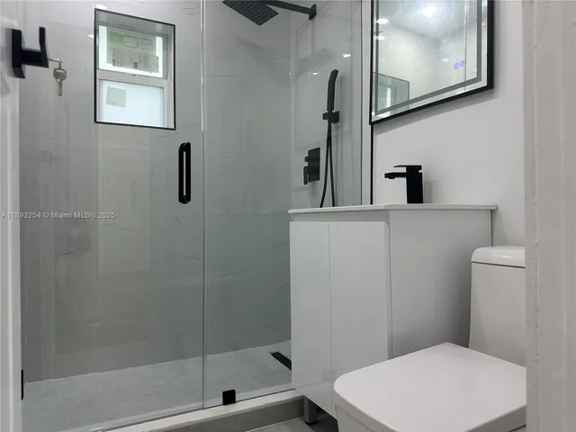 a bathroom with a toilet a sink and shower