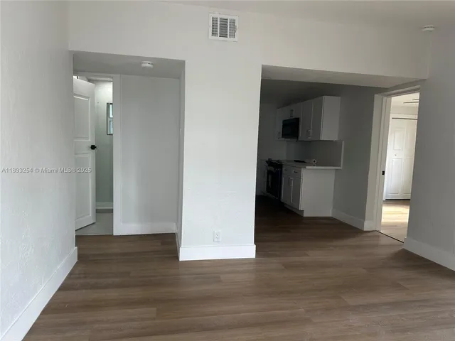 a view of hallway with wooden floor