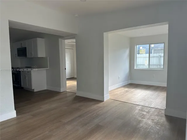 an empty room with closet and windows