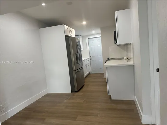 a kitchen with a refrigerator and a sink
