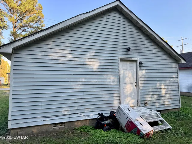 a view of a backyard with a large tree