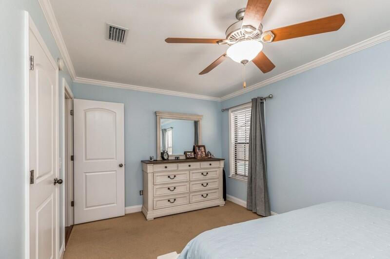 1164 Driftwood Point Road Santa Rosa Beach, FL 32459 - Photo 17 of 39 a bedroom with a dresser and a chandelier