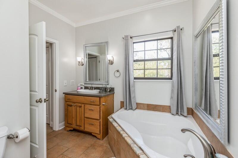 1164 Driftwood Point Road Santa Rosa Beach, FL 32459 - Photo 24 of 39 a bathroom with a tub sink and mirror