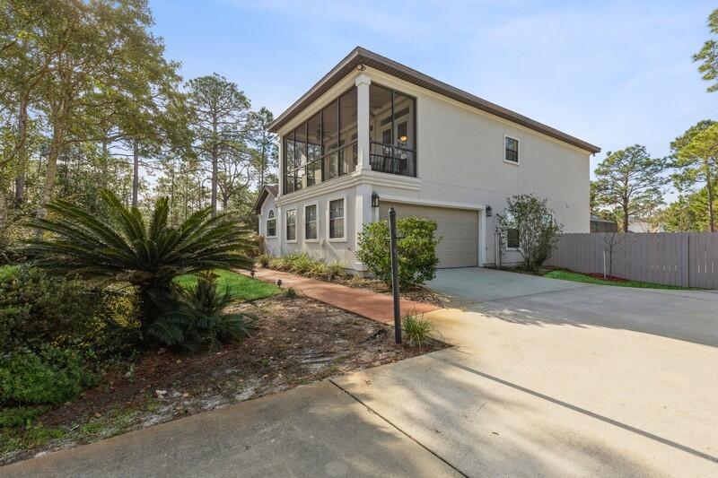 1164 Driftwood Point Road Santa Rosa Beach, FL 32459 - Photo 3 of 39 a front view of a house with garden