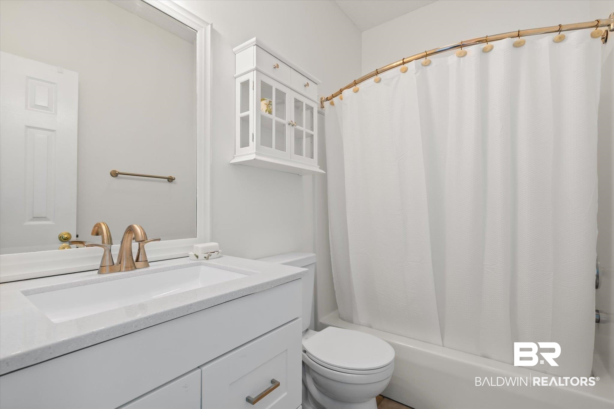 3575 Bayou Road, Unit A 10 Orange Beach, AL 36561 - Photo 18 of 31 Full bathroom featuring vanity, toilet, and shower / bathtub combination with curtain