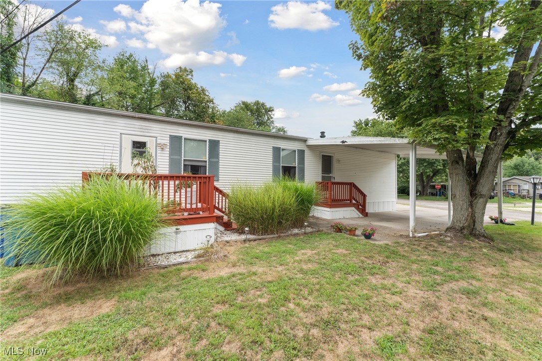 6615 Cleveland Road, Unit K2 Ravenna, OH 44266 - Photo 4 of 24 Back of property with an attached carport and a yard