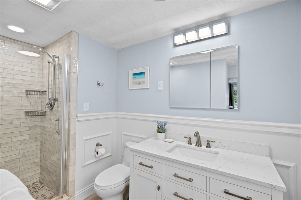 13 Pinewood Drive Framingham, MA 01701 - Photo 14 of 21 a bathroom with a granite countertop sink a toilet and a mirror