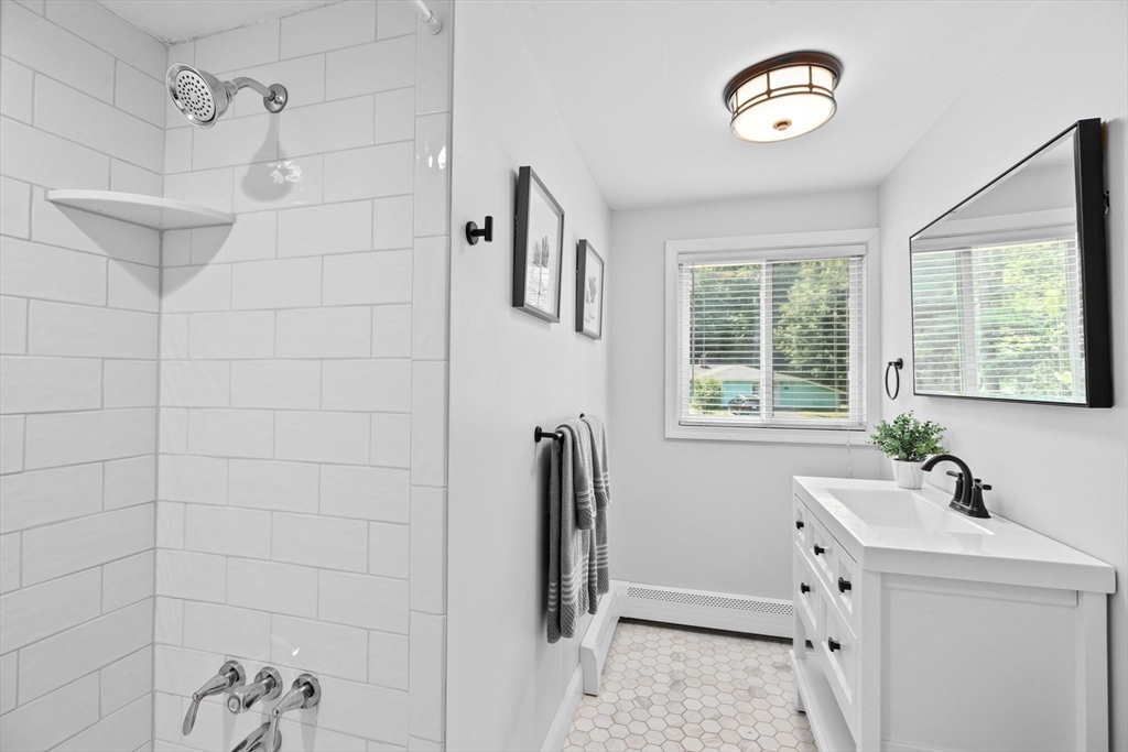 13 Pinewood Drive Framingham, MA 01701 - Photo 18 of 21 a bathroom with a tub sink and mirror