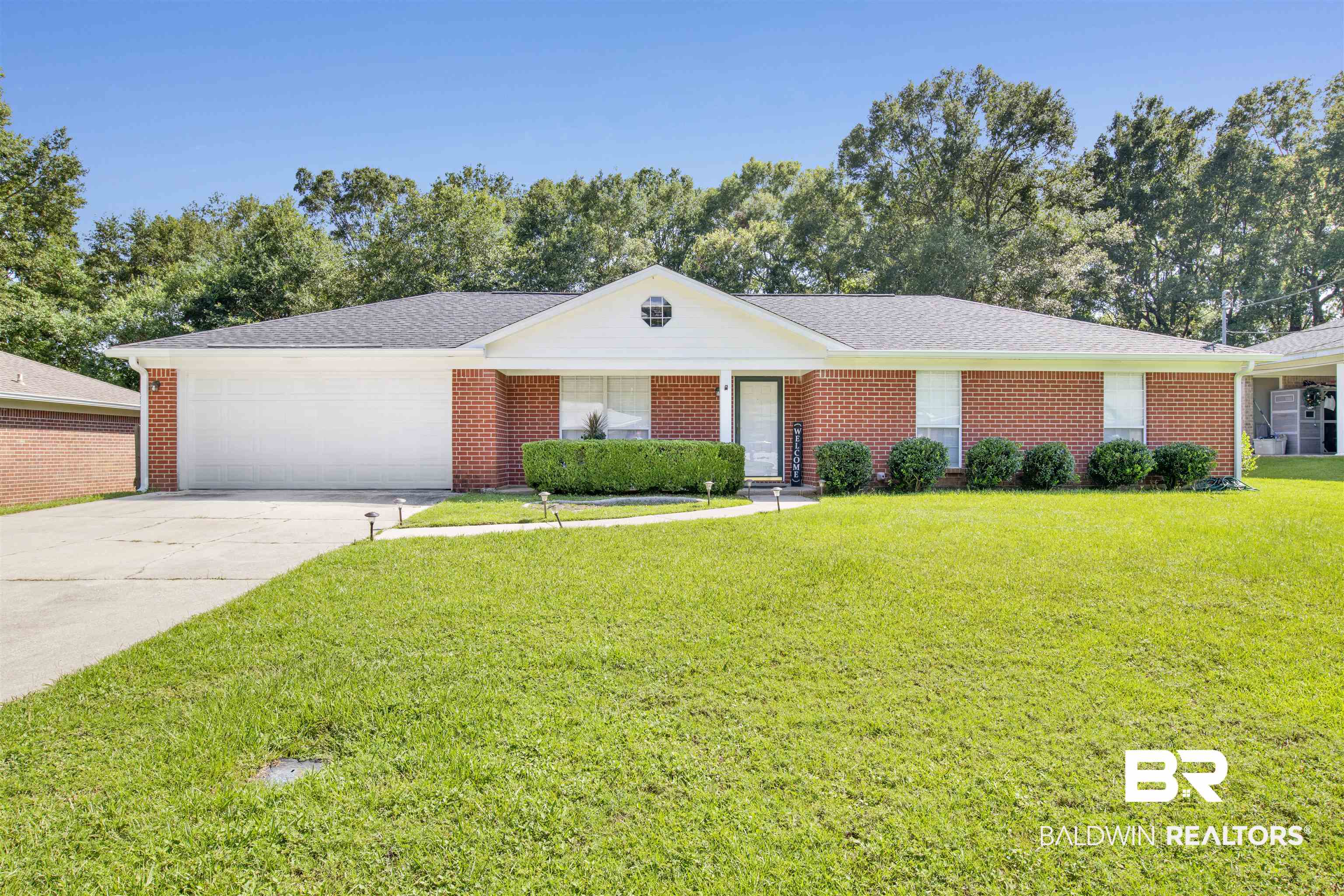 6281 Woodside Drive Theodore, AL 36582 - Photo 1 of 17 Single story home with a front lawn, driveway, an attached garage, and brick siding