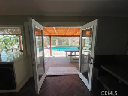 a view of a patio with lawn chairs next to a yard