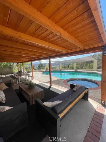 a view of a porch with chairs and backyard