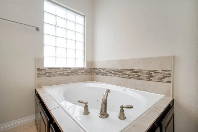 a bath tub sitting in a bathroom next to a window