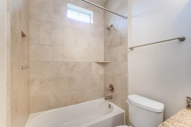 a bathroom with a bathtub and a toilet