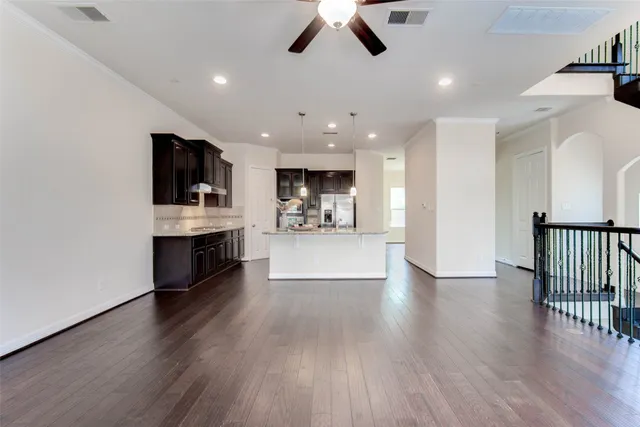 a view of a kitchen and a stove wooden floor windows