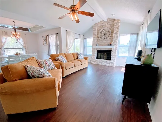 a living room with furniture a fireplace and a flat screen tv