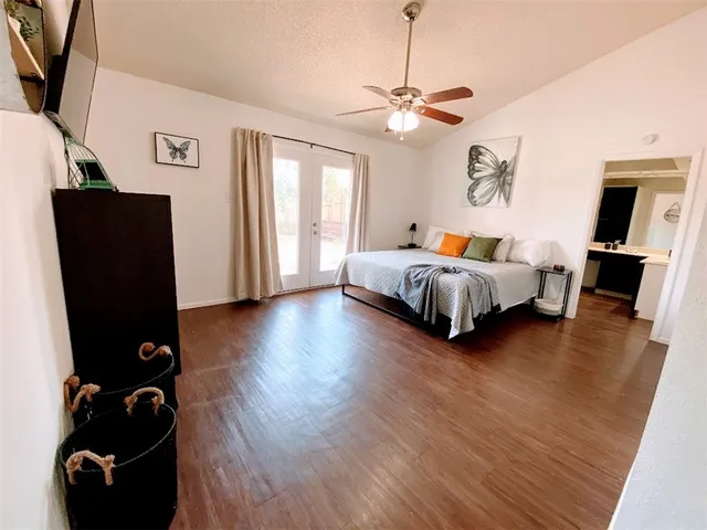 a spacious bedroom with bed and window