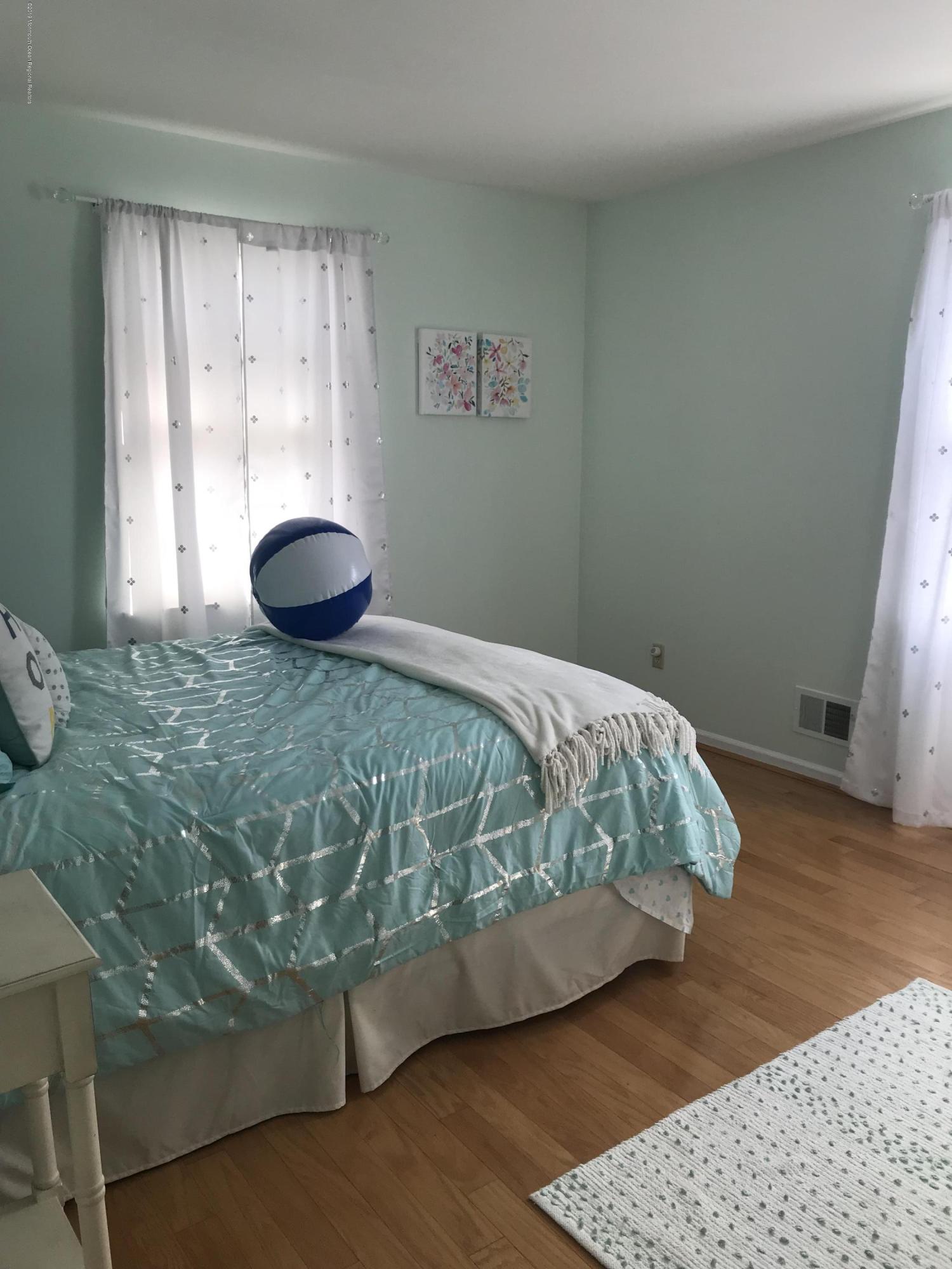 16 Webb Avenue Ocean Grove, NJ 07756 - Photo 16 of 32 a bedroom with a bed and a window